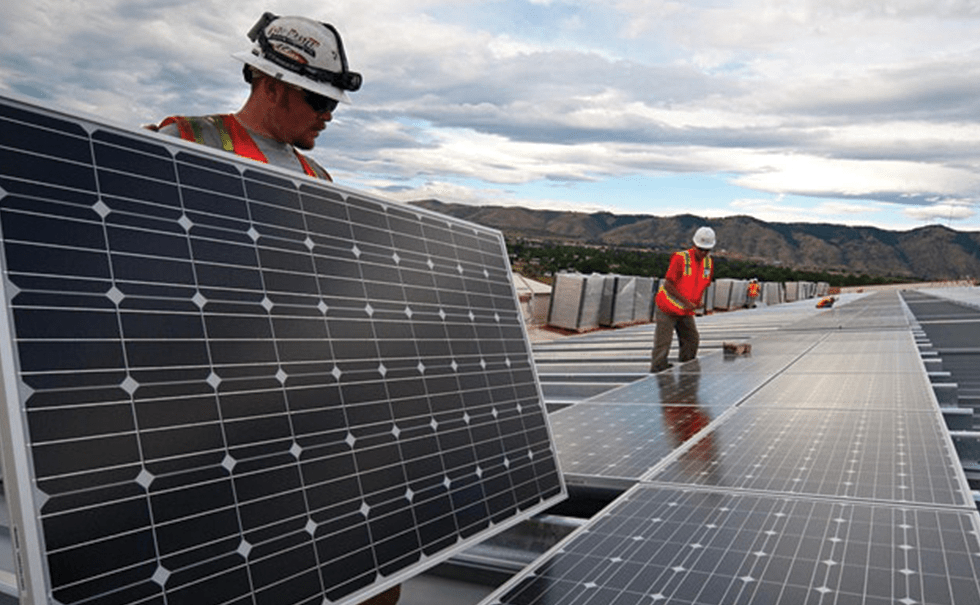 Picture of two people installing solar panels